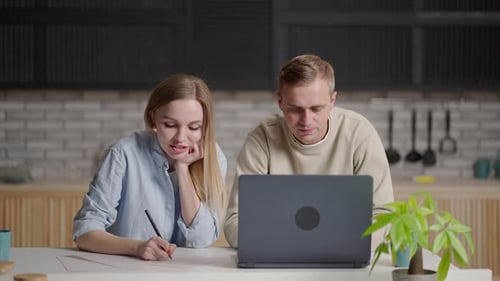 Couple Working Together at Home with Laptop