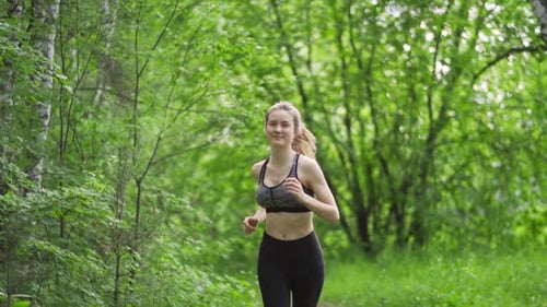 Young Woman Runner Training in Summer Park