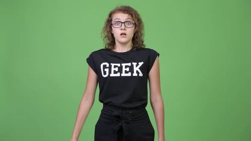Surprised Young Woman Reacts in Front of Green Screen