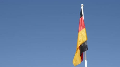 German Flag Waving Against Blue Sky