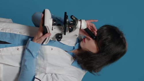 Female Scientist Uses Laboratory Microscope For Research