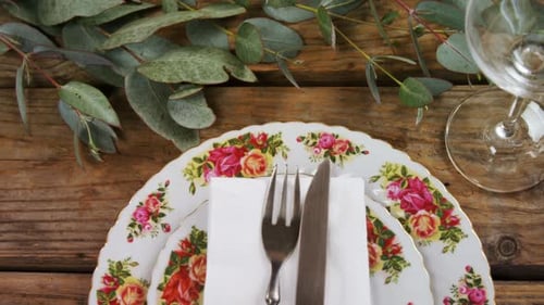 Elegant Table Setting with Floral Plates and Silverware