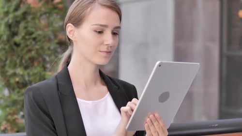 Woman Using Tablet in Urban Environment