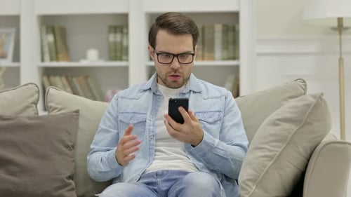 Frustrated Man Reacts to Bad News on Phone