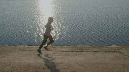 Strong Man Is Running Near Lake