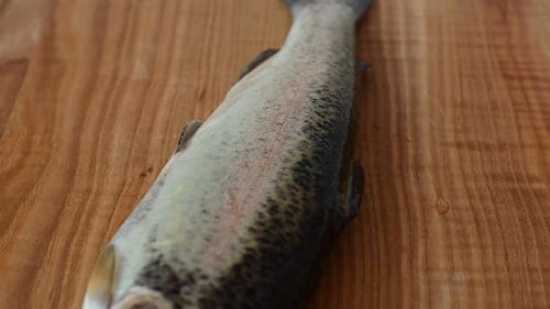 Close up of trout on wood cutting board