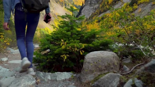 Woman Hiking Through Autumn Mountain Landscape