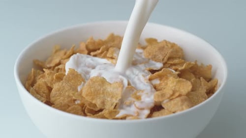 Milk Poured Over Corn Flakes for Breakfast