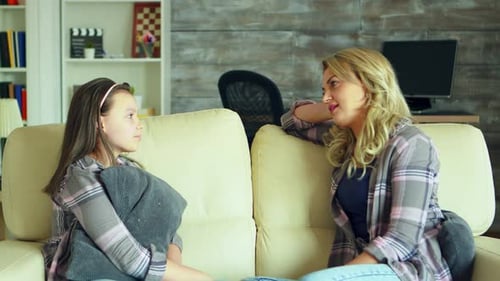 Woman and Child Talking on Couch Indoors
