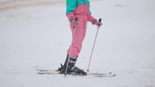 Young Woman Skiing on a Snowy Mountain