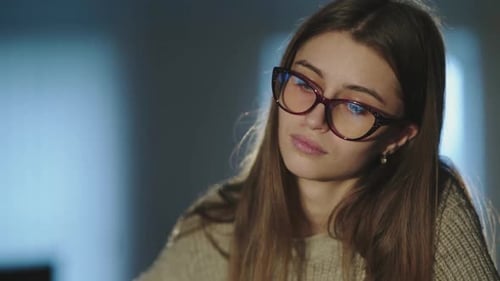 Tired Student Notes at Desk Takes Off Glasses and Thinks When Leaning on Hand