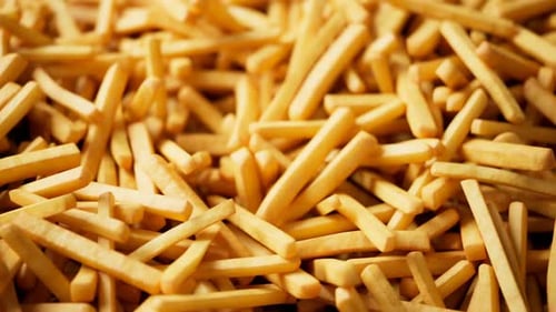 Dynamic Pile of Animated Golden French Fries Background