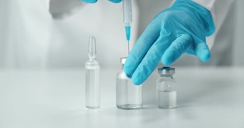 Doctor Filling Syringe with Vaccine