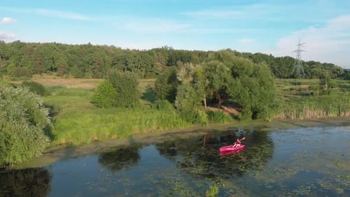 Woman Kayaking on a Peaceful Lake
