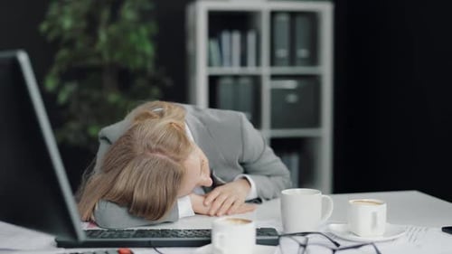 Exhausted Woman Napping at Office
