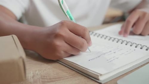 Close Up Of Hand's Man Writing In The Notebook