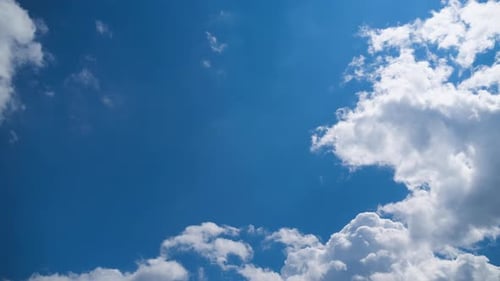 Clouds Drifting Slowly Across Blue Sky