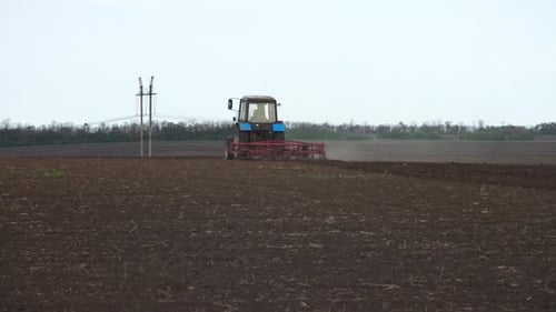 Tractor plows the farm field