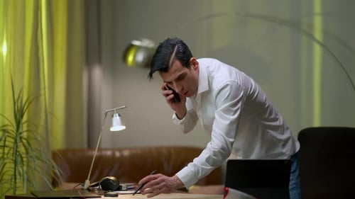 Busy Overworking Middle Eastern Man Drawing Architectural Plan Answering Phone Call