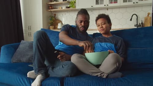 Father and Son Watching TV Together