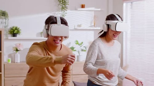 Excited Couple Experiencing Virtual Reality in Living Room