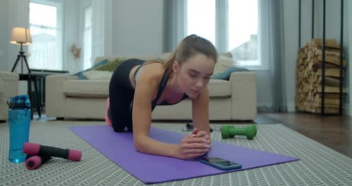 Fit Woman Doing Plank Exercise at Home