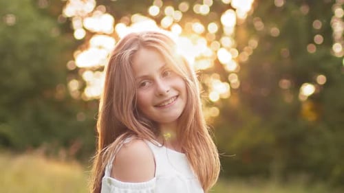 Smiling Girl in Park During Golden Hour