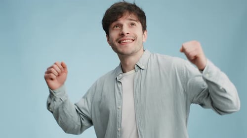 Man Cheering and Waving in a Studio Setting
