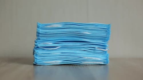 Stack of Light Blue Medical Face Masks Close Up