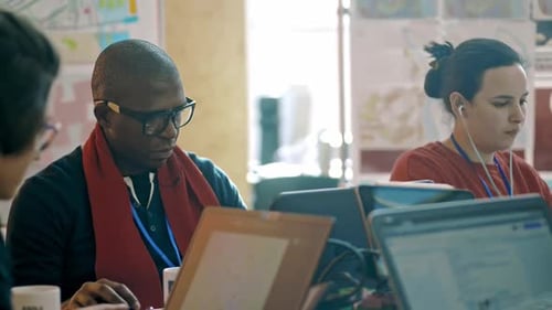 Group of Multiethnic Students Are Working with Computers at Desk in University Campus Irrl