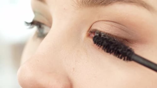 Close Up of Young Female Applying Mascara on Her Eyelashes