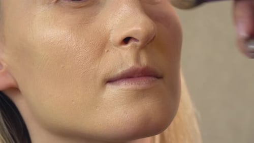 A Client in a Beauty Salon Does Makeup
