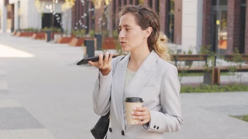 Woman Using Voice Command on Phone Outdoors