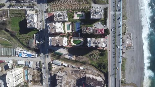 Aerial View Flying over the Main Street in the Resort Town Near the Embankment