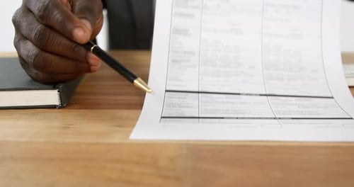 Businessman Holding Insurance Form Explaining Coverage