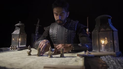 Man Strategizes with Map and Chess Pieces at Night