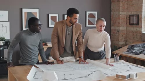 Architects Collaborating on Project in Creative Office