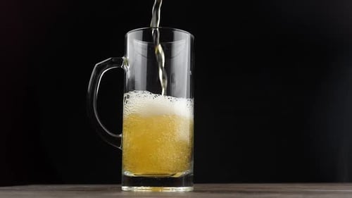 Golden Beer Poured into Handled Glass Mug