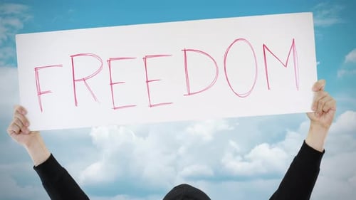 FREEDOM Text on a Placard Against Blue Sky