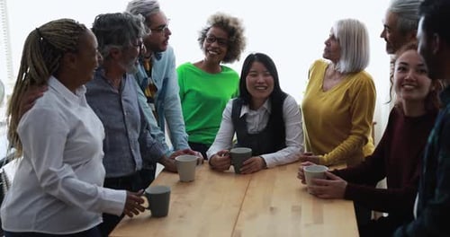 Diverse Group of Friends Talking Around a Table