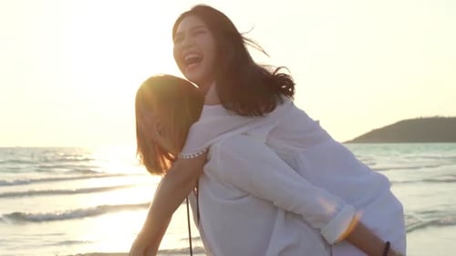 LGBT friends playing on beach, beautiful women friends feel happy and fun relax playing on beach.