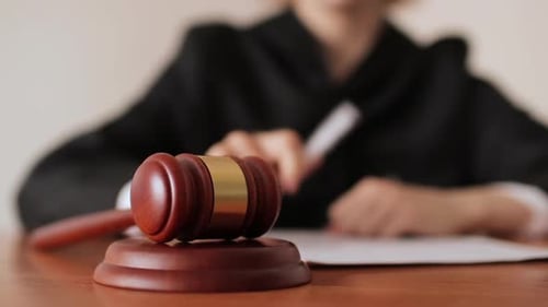 Gavel Strikes Sounding Block in Courtroom