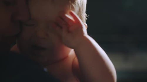 Precious Infant Cradled Calmly in Arms