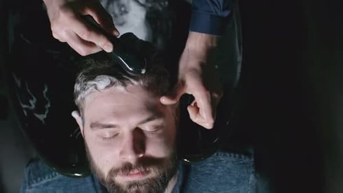 Man Receives Hair Wash and Massage at Barber Shop