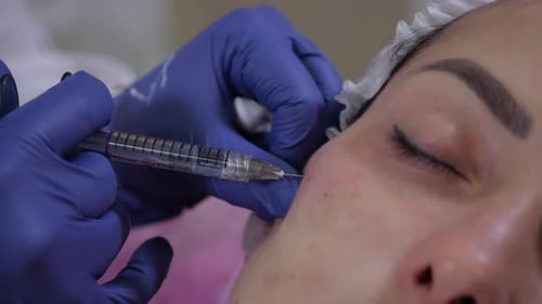 Woman Receiving Facial Injections at Medical Clinic