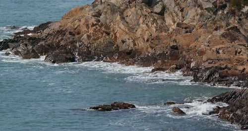 Sea water wave with stone cliff