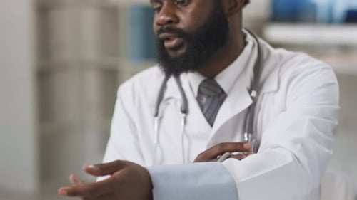 Doctor Attaches Blood Pressure Cuff in Office