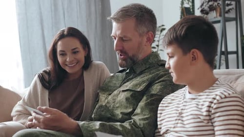 Family Looking at Photos on Couch