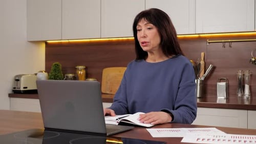 Woman Talking in a Video Conference in Kitchen