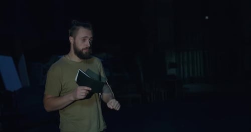 The Actor Rehearses the Role Himself and Spies on the Script in a Dark Theater